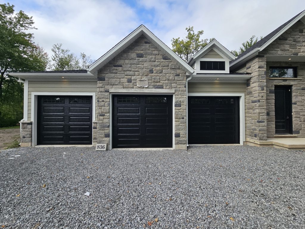 Beige garage with new insulated garage door installed by Pro Entry Garage Doors