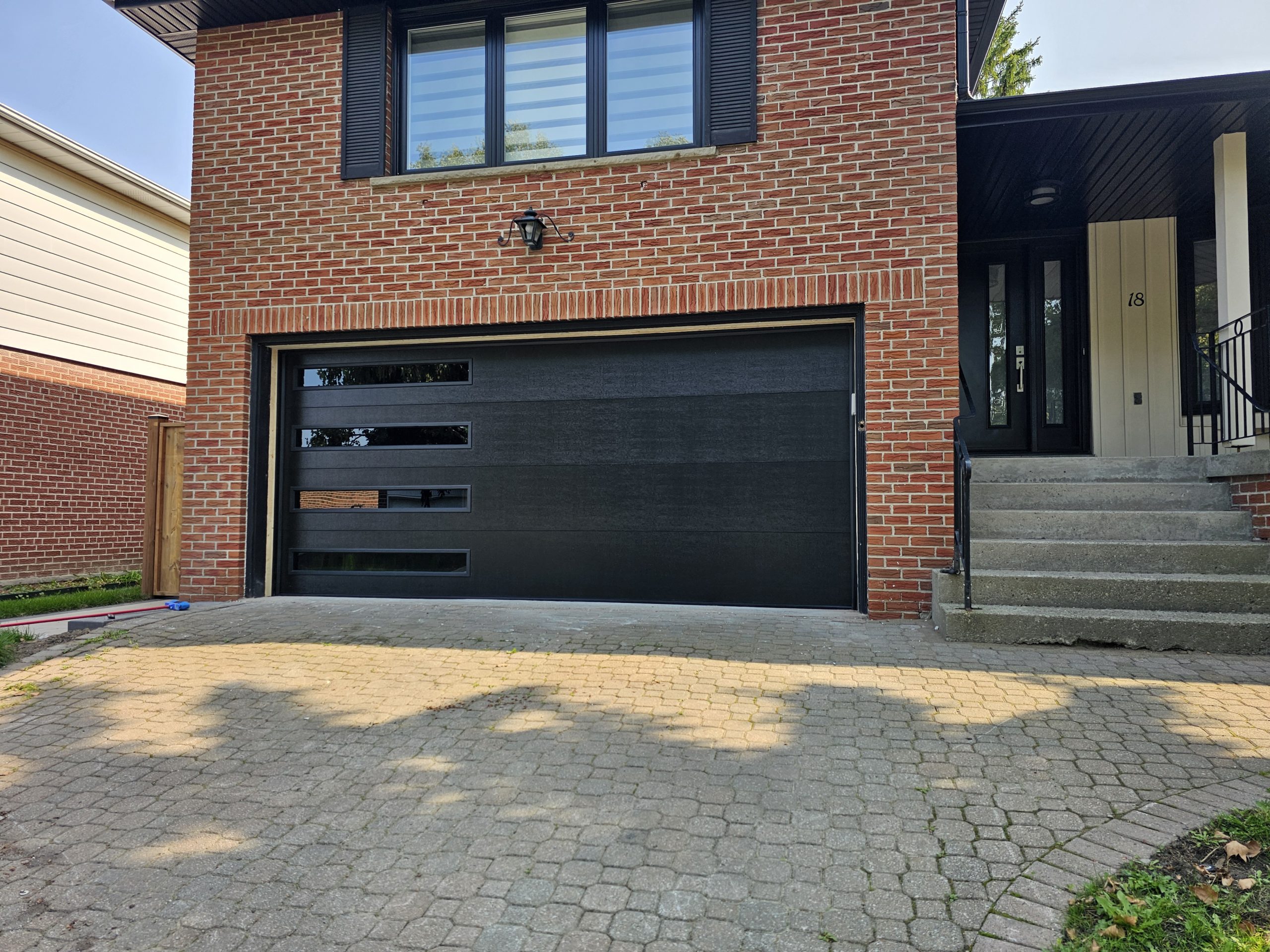 Modern black garage door with windows