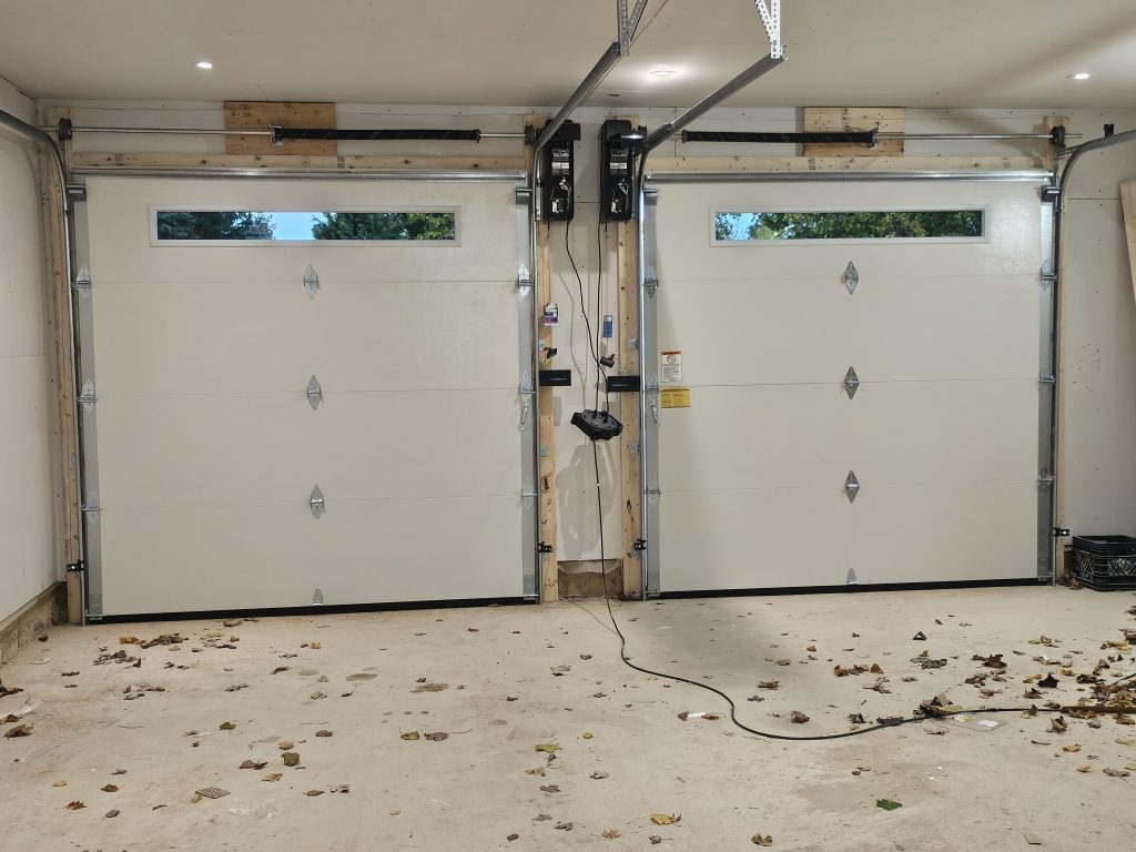 Garage door replacement in progress by Pro Entry technician