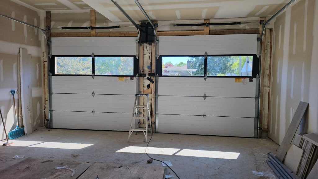 Garage door track and spring repair in progress
