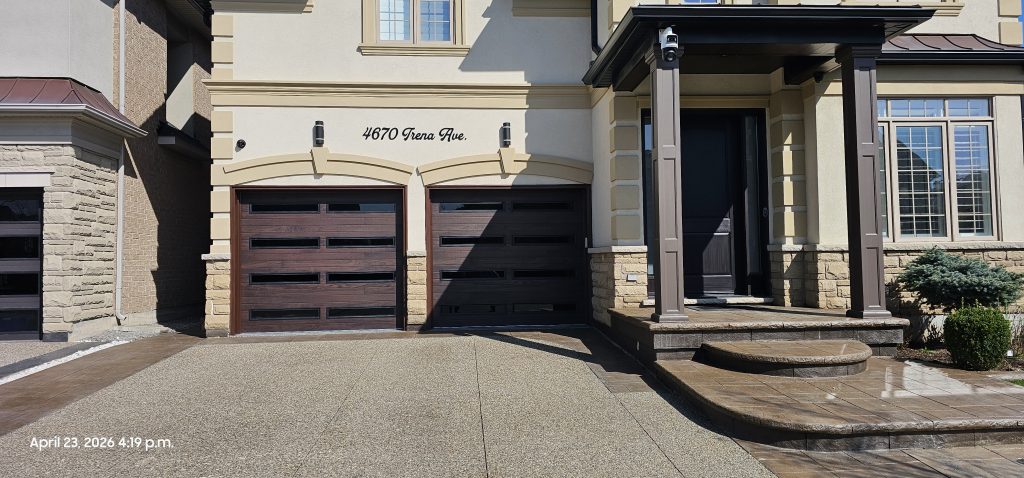 Brown wood-look garage door with windows installed in the GTA