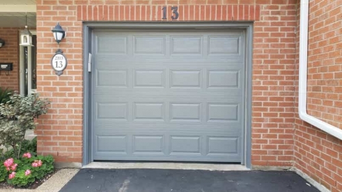 Grey single-car modern garage door without windows installed in Oakville by Pro Entry