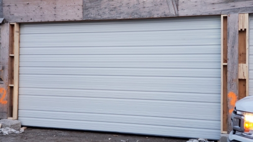 white color garage door with no windows installed by Pro Entry Services