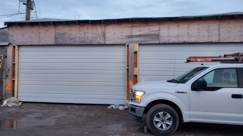 white color garage doors with no windows installed by Pro Entry Services