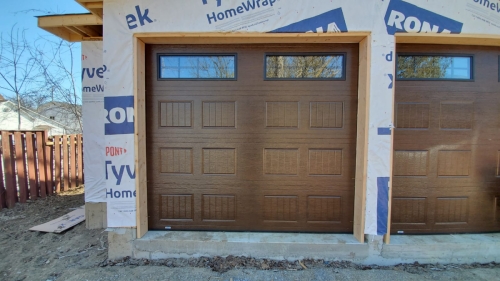 Traditional style brown color garage door installed for a house in Milton by Pro Entry Services